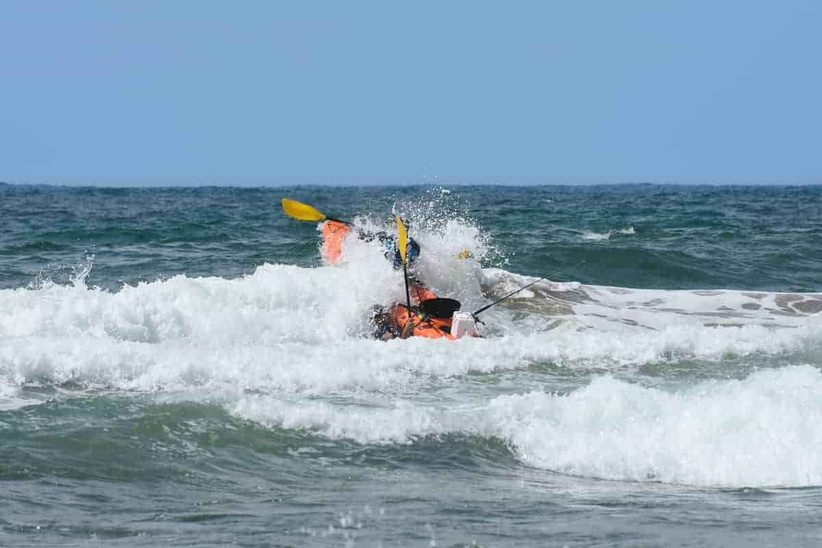 Photo of Kayak Crashing Through Surf